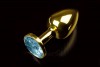 Маленькая золотистая анальная пробка с круглым кончиком и голубым кристаллом - 7 см. фото 1 — pink-kiss