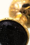 Маленькая золотистая анальная втулка с чёрным кристаллом - 7,2 см. фото 4 — pink-kiss